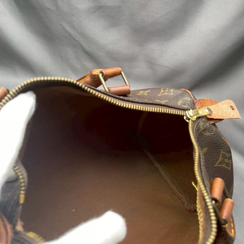 Inside the Louis Vuitton Speedy 30, showing the brass zipper pull and interior lining